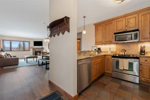 a kitchen with stainless steel appliances a stove sink microwave and cabinets