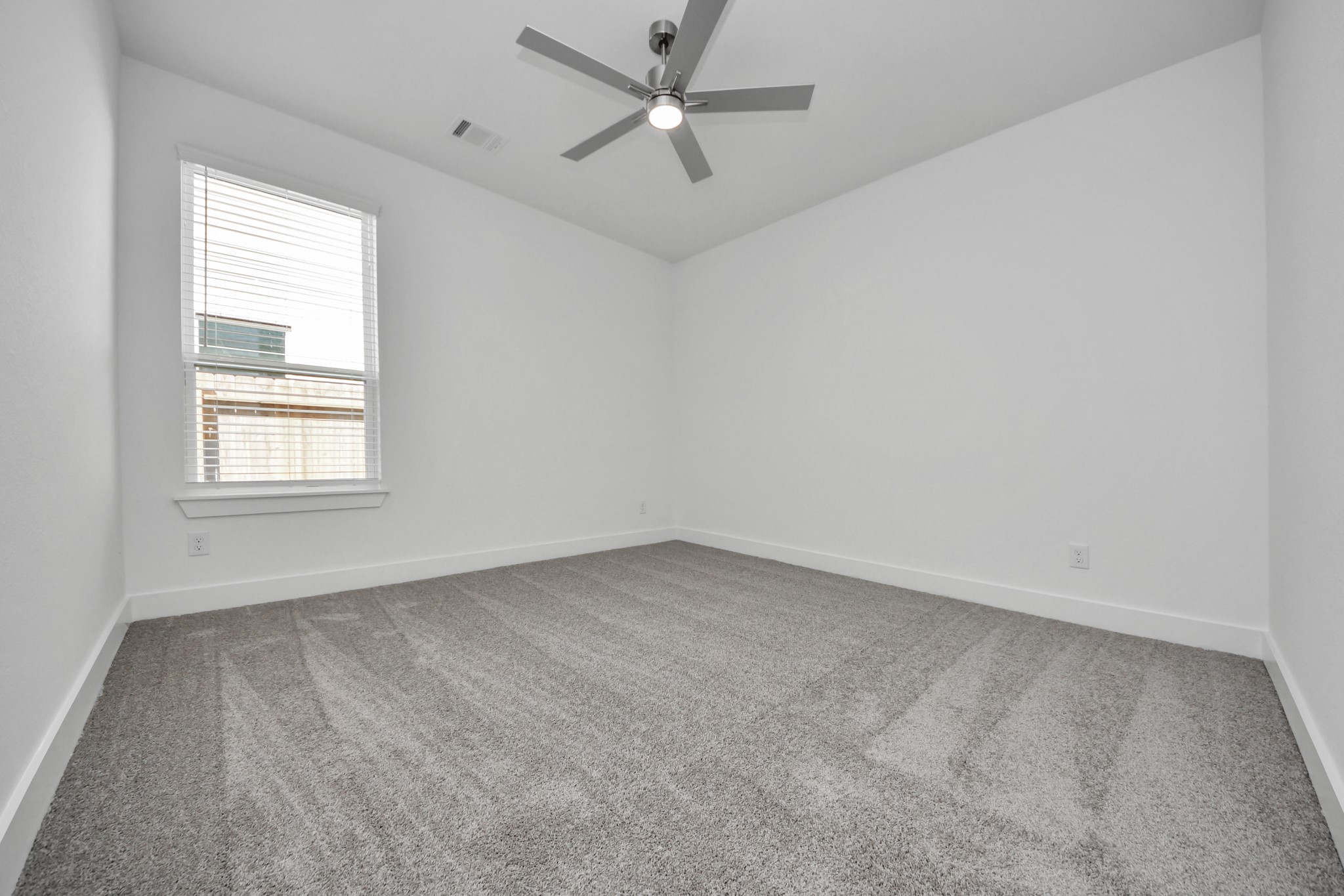 3042 Native Spg Drive Spring, TX 77373 - Photo 13 of 40 Secondary bedroom features plush carpeting, large windows that let in plenty of natural light, bright paint, and spacious closets.