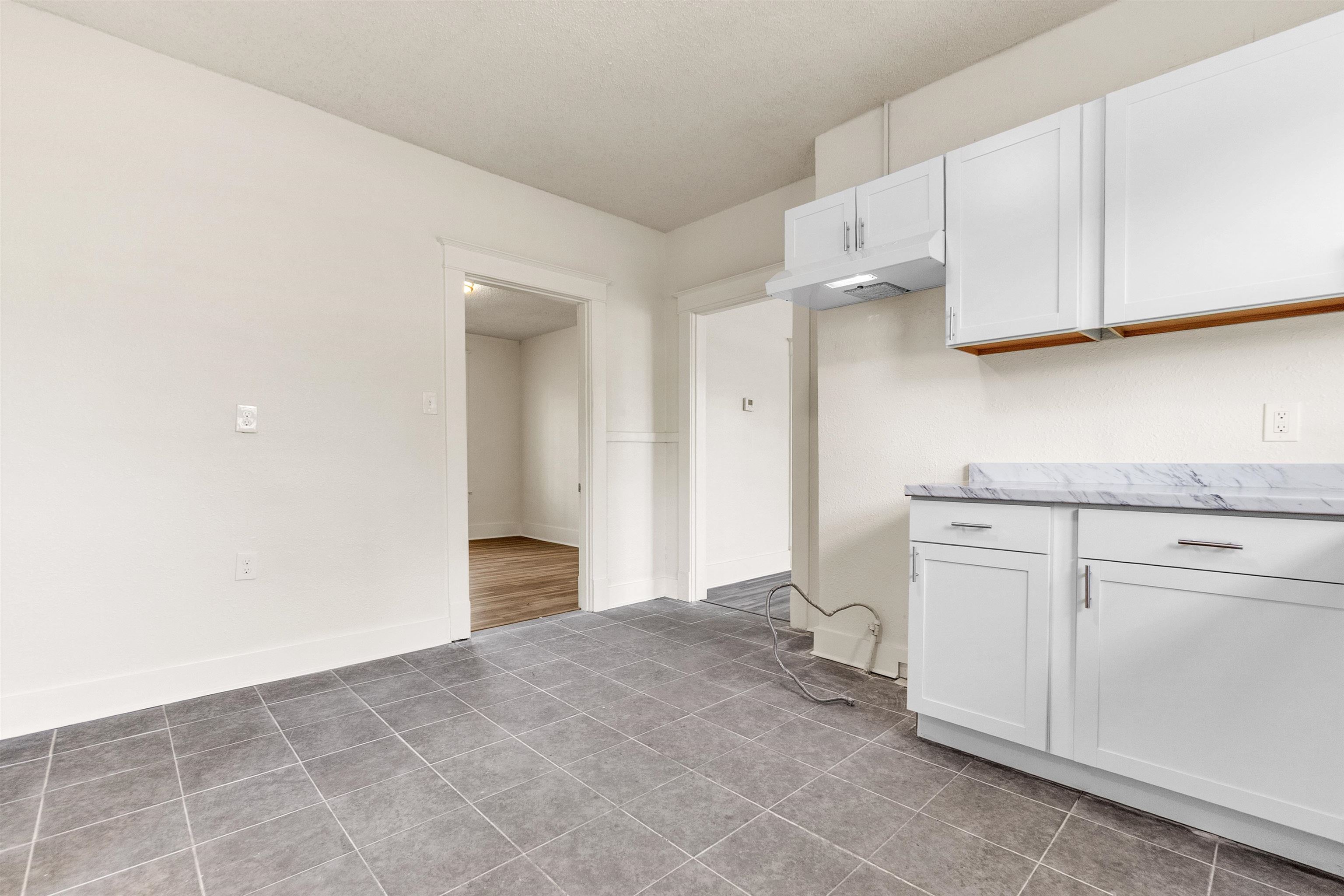 1100 Rozelle Street Memphis, TN 38106 - Photo 14 of 19 a kitchen with white cabinets and white appliances