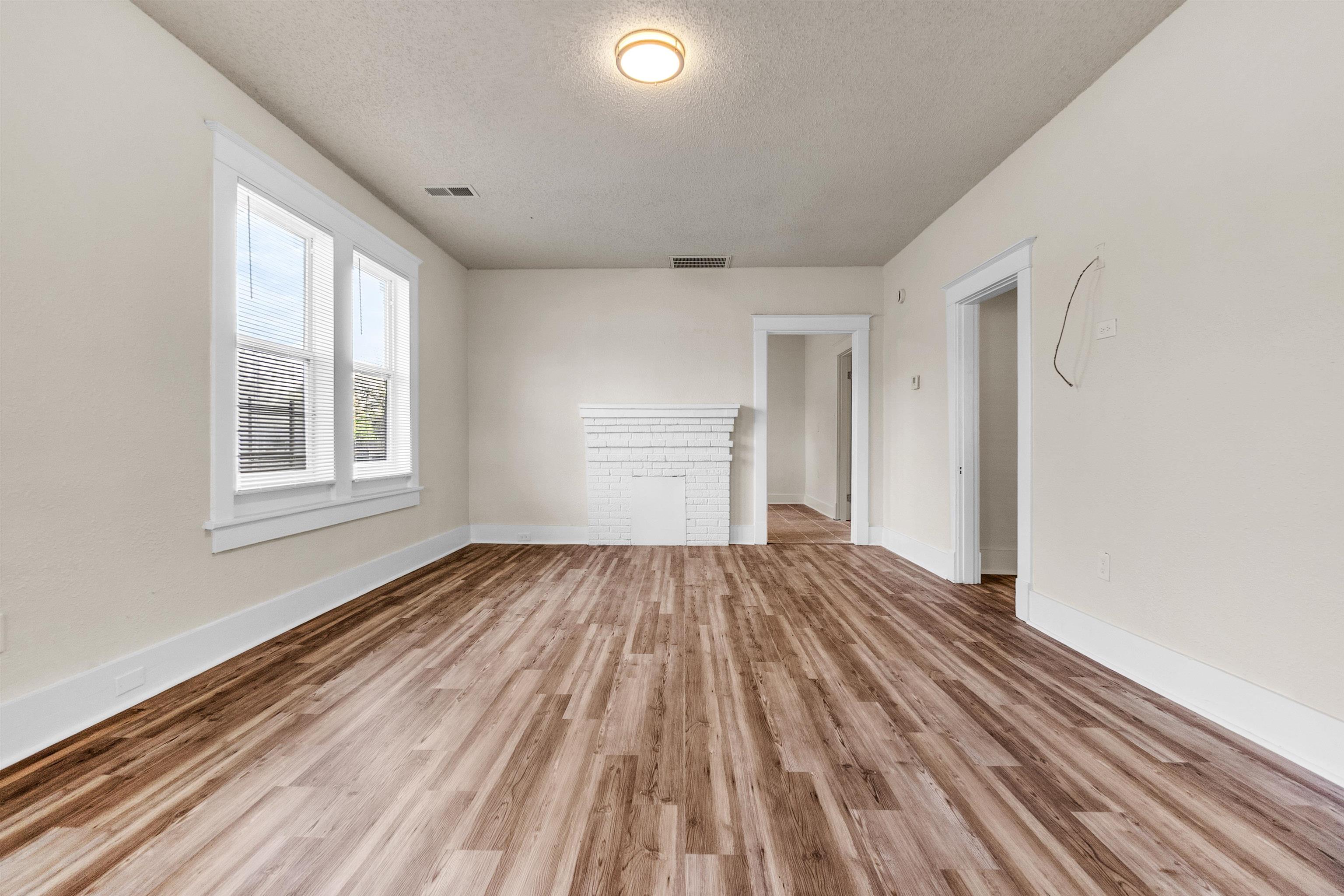 1100 Rozelle Street Memphis, TN 38106 - Photo 6 of 19 a view of empty room with wooden floor and fan