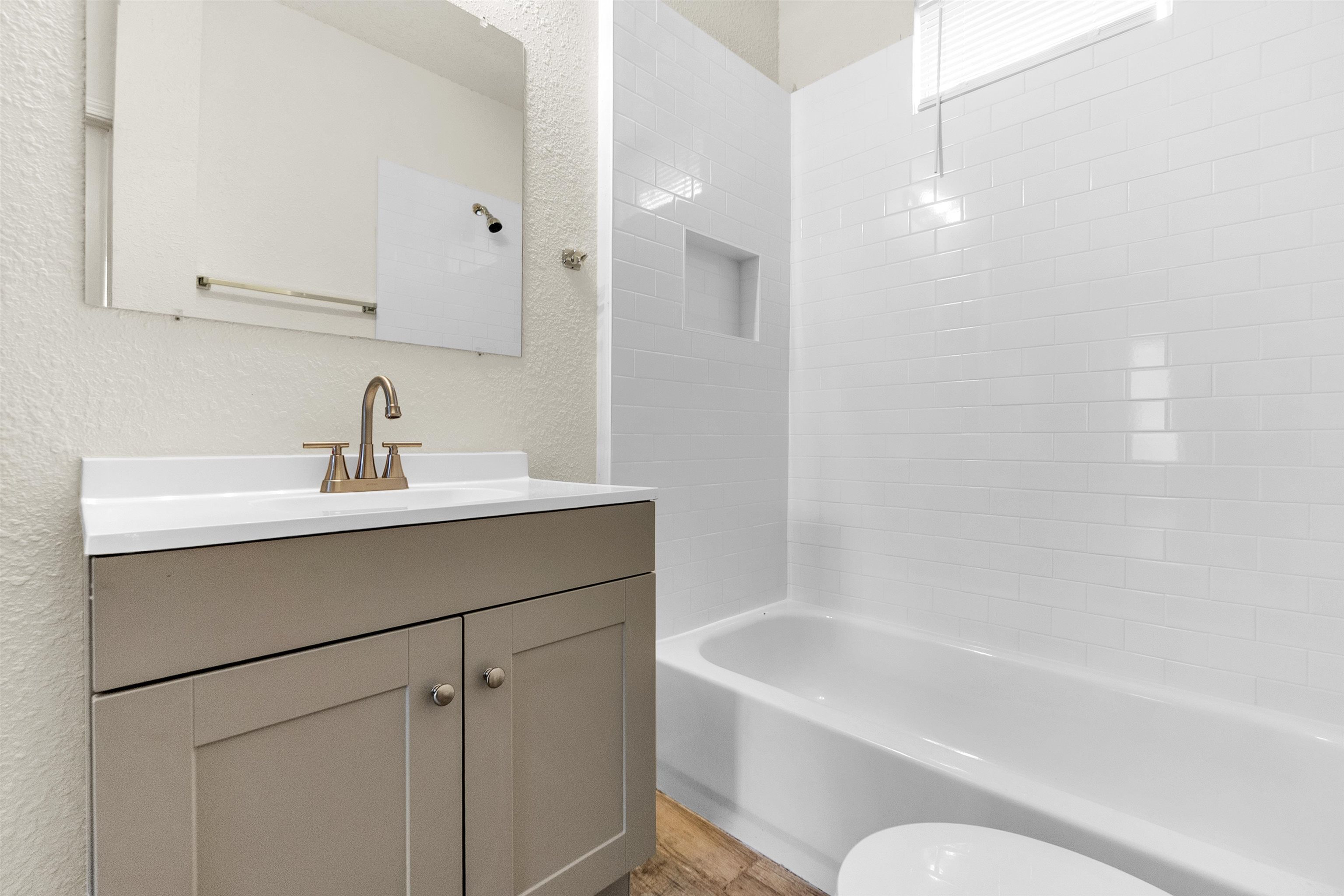 1100 Rozelle Street Memphis, TN 38106 - Photo 8 of 19 a bathroom with a bathtub sink vanity and mirror