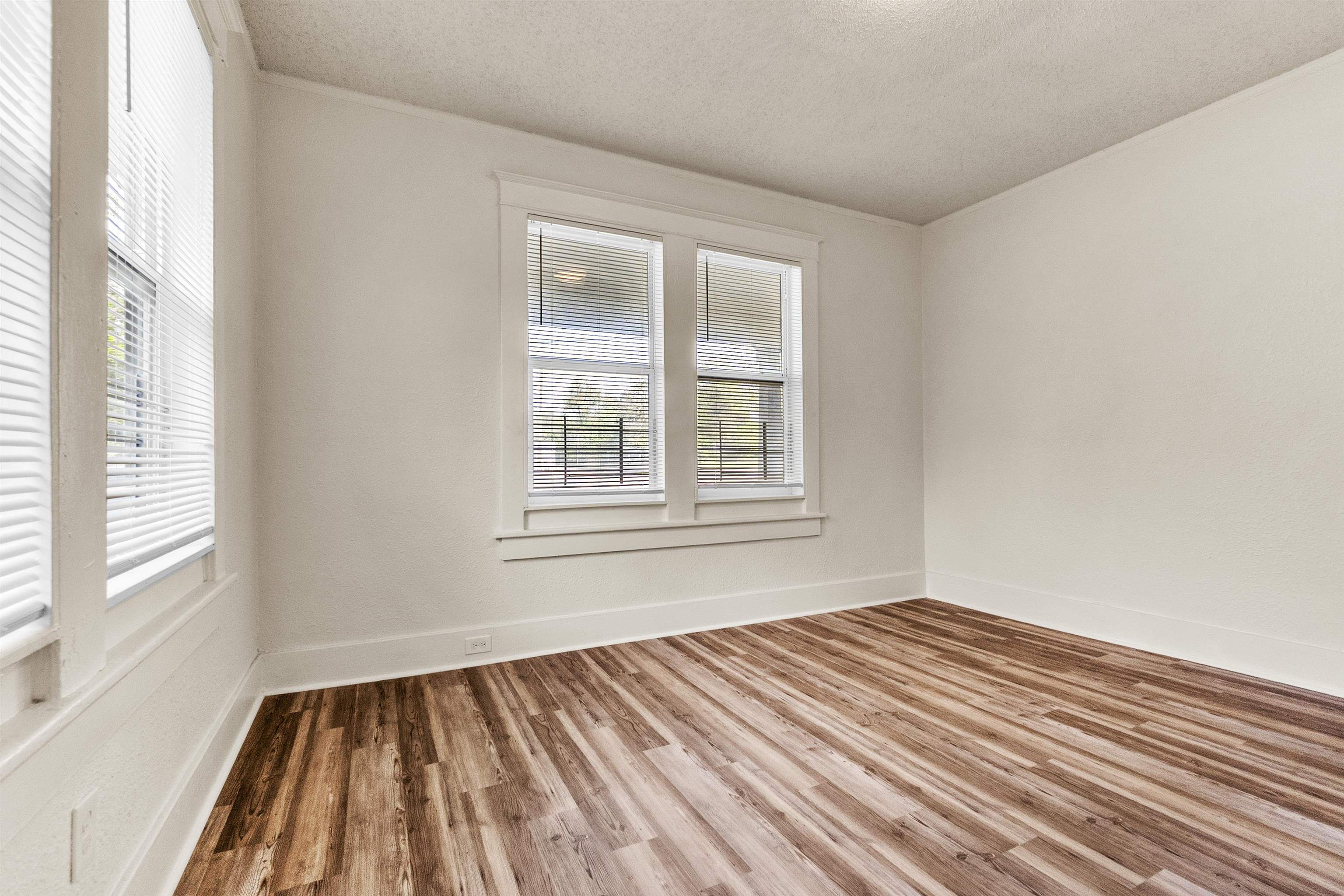 1100 Rozelle Street Memphis, TN 38106 - Photo 9 of 19 a view of an empty room with wooden floor and a window