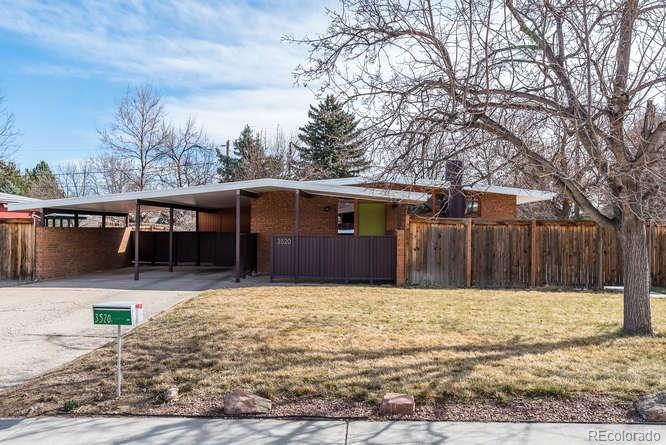 3520 Ward Road Wheat Ridge, CO 80033 - Photo 1 of 22 a front view of house with yard covered in snow