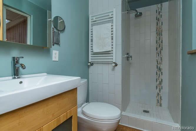 3520 Ward Road Wheat Ridge, CO 80033 - Photo 13 of 22 a bathroom with a sink a toilet and shower