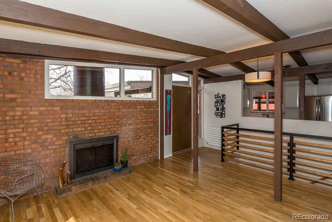 3520 Ward Road Wheat Ridge, CO 80033 - Photo 6 of 22 a view of a livingroom with furniture and fireplace