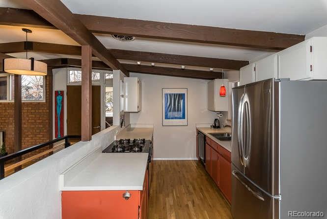 3520 Ward Road Wheat Ridge, CO 80033 - Photo 9 of 22 a kitchen with refrigerator and stove