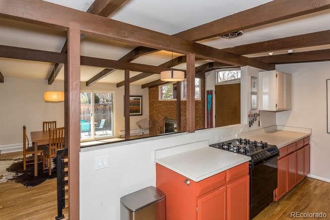 3520 Ward Road Wheat Ridge, CO 80033 - Photo 10 of 22 a kitchen that has a stove and a table