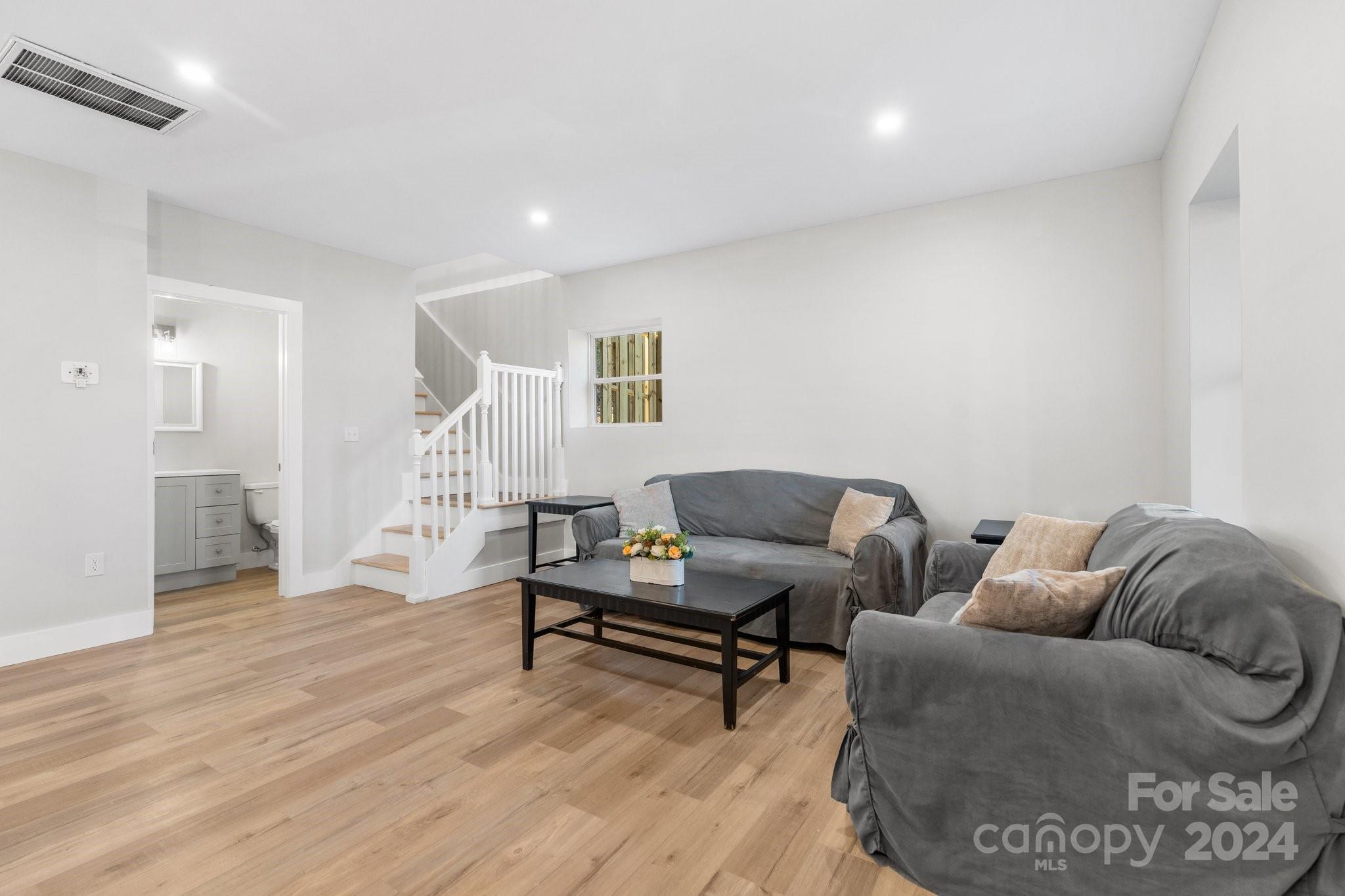 32 Access Road Black Mountain, NC 28711 - Photo 11 of 34 a living room with furniture and a wooden floor