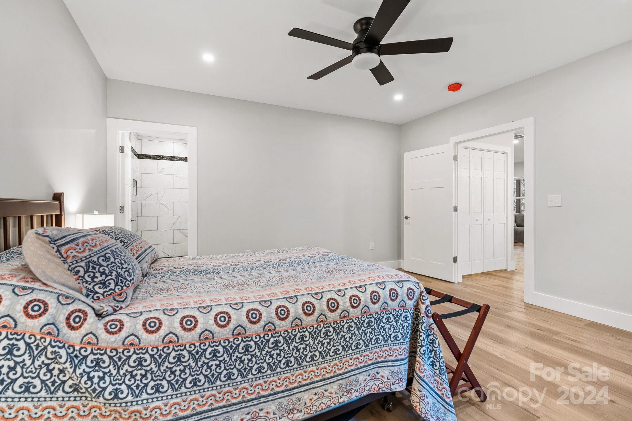 32 Access Road Black Mountain, NC 28711 - Photo 13 of 34 a bedroom with a large bed and a chandelier
