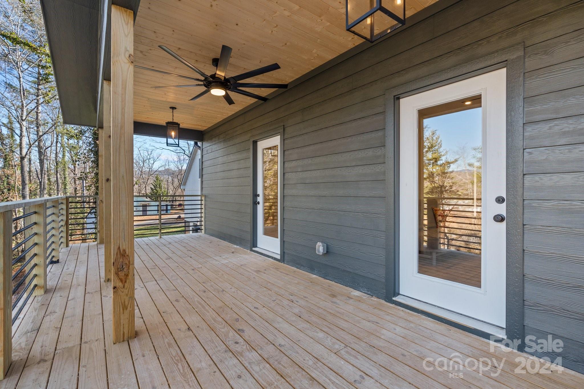 32 Access Road Black Mountain, NC 28711 - Photo 20 of 34 a view of a room with wooden floor and a ceiling fan