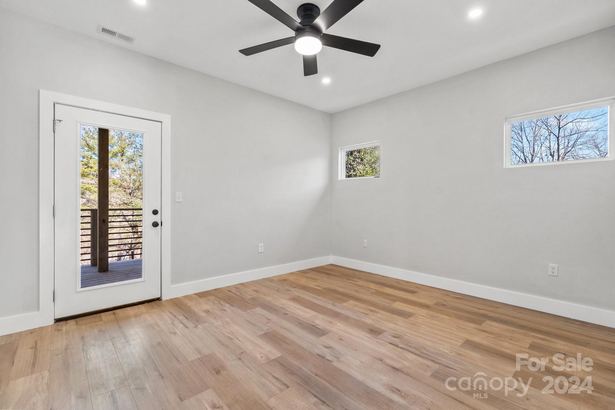 32 Access Road Black Mountain, NC 28711 - Photo 23 of 34 wooden floor in an empty room with a window
