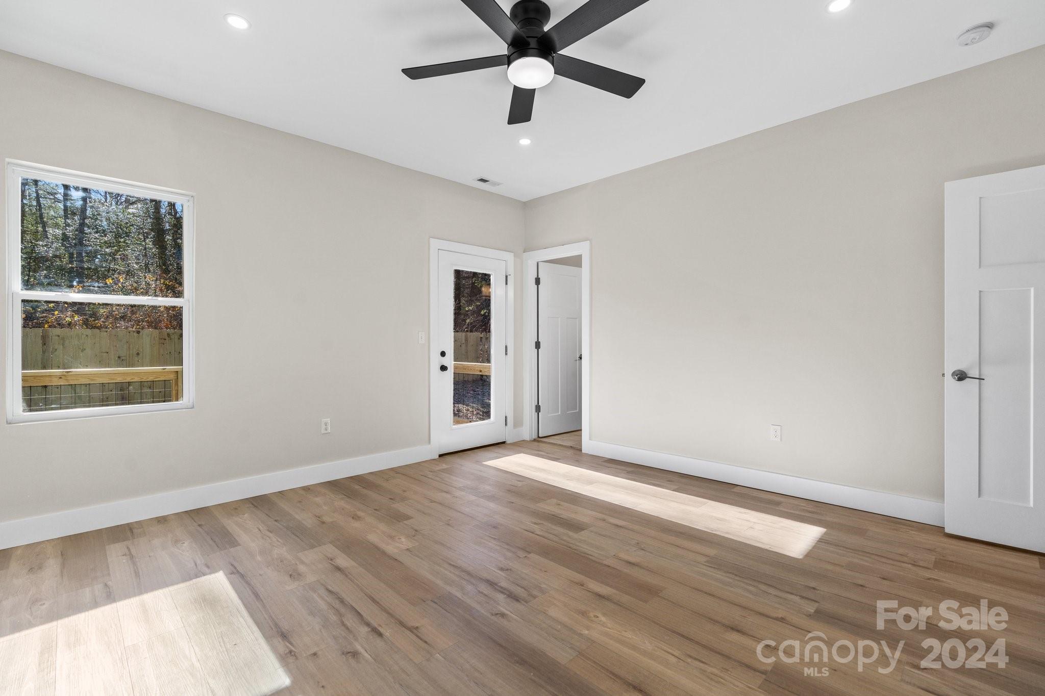 32 Access Road Black Mountain, NC 28711 - Photo 24 of 34 a view of an empty room with window and wooden floor