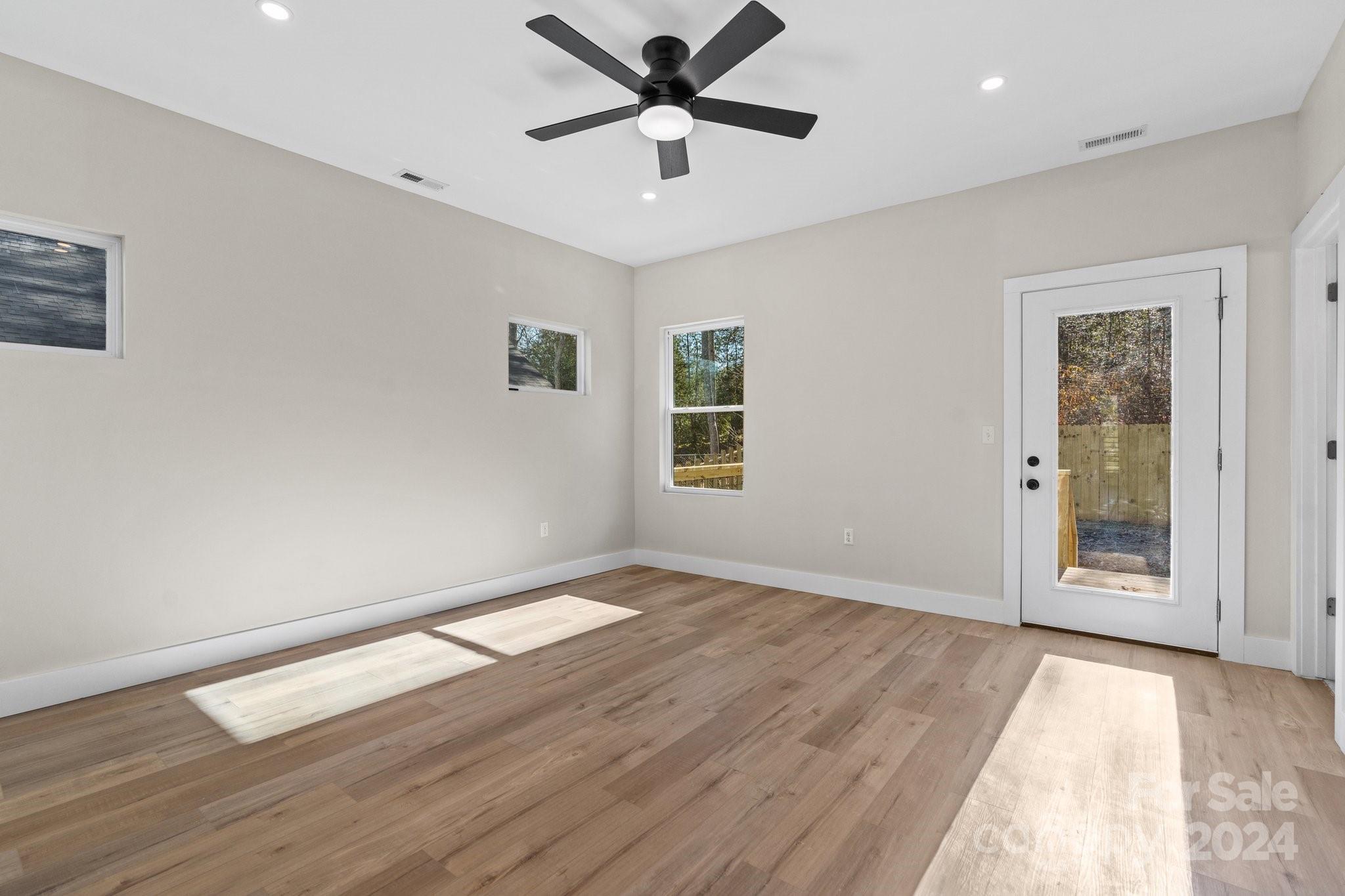 32 Access Road Black Mountain, NC 28711 - Photo 25 of 34 a view of a big room with wooden floor and a ceiling fan