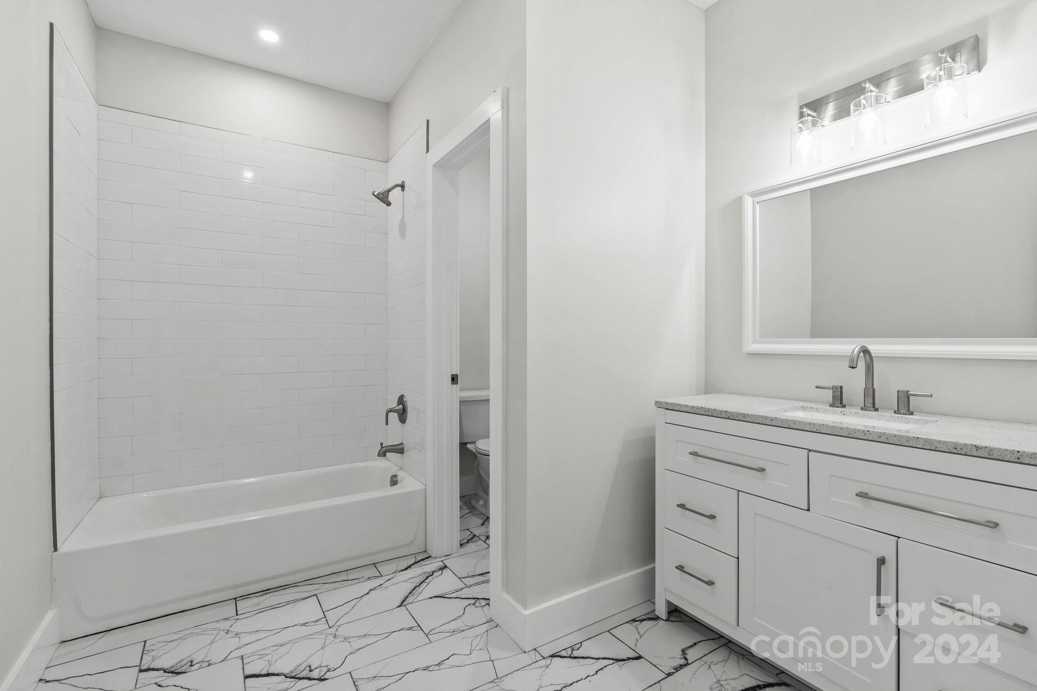 32 Access Road Black Mountain, NC 28711 - Photo 28 of 34 a spacious bathroom with a bathtub sink and toilet