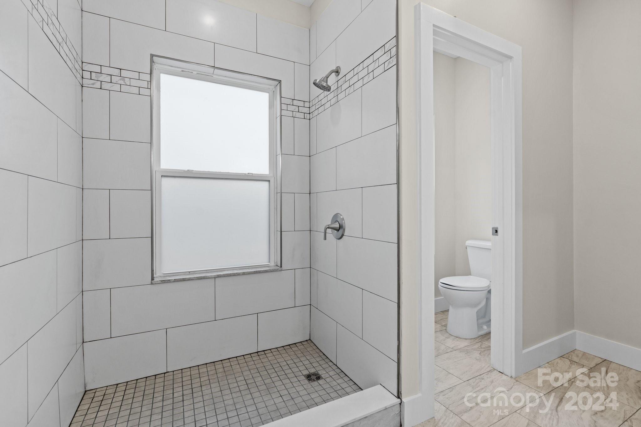 32 Access Road Black Mountain, NC 28711 - Photo 29 of 34 a bathroom with a shower and toilet