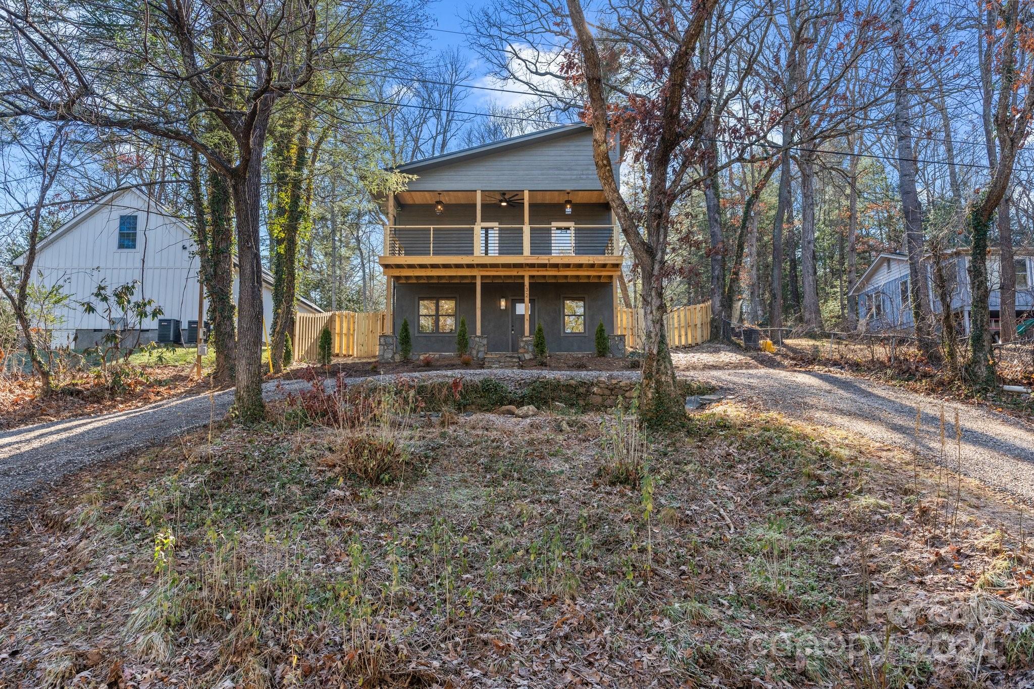 32 Access Road Black Mountain, NC 28711 - Photo 31 of 34 a front view of a house with a yard and large trees