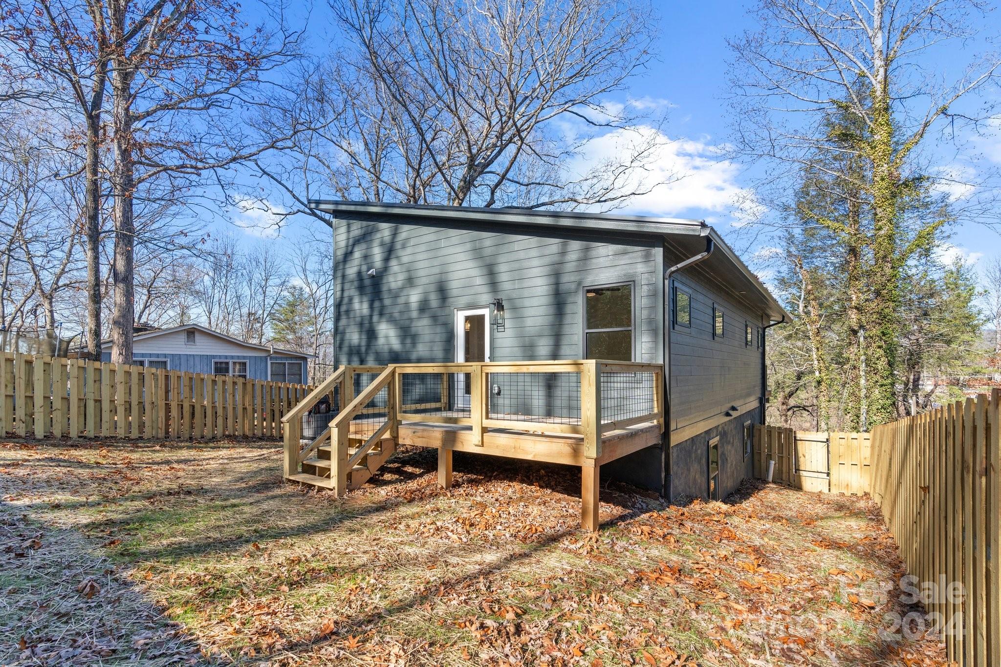 32 Access Road Black Mountain, NC 28711 - Photo 32 of 34 a view of a house with a wooden deck and a large tree