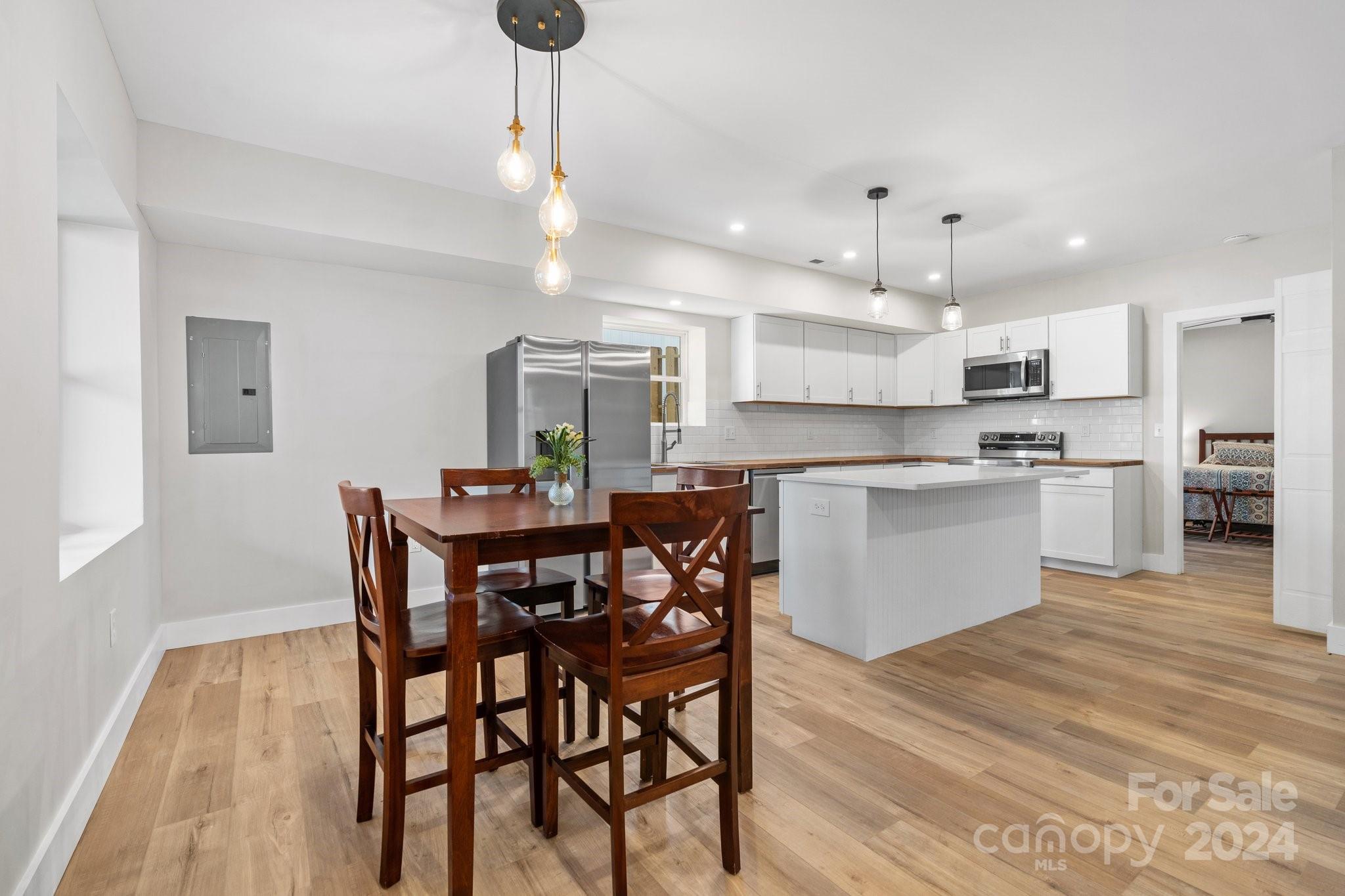 32 Access Road Black Mountain, NC 28711 - Photo 10 of 34 a kitchen with kitchen island a dining table and chairs