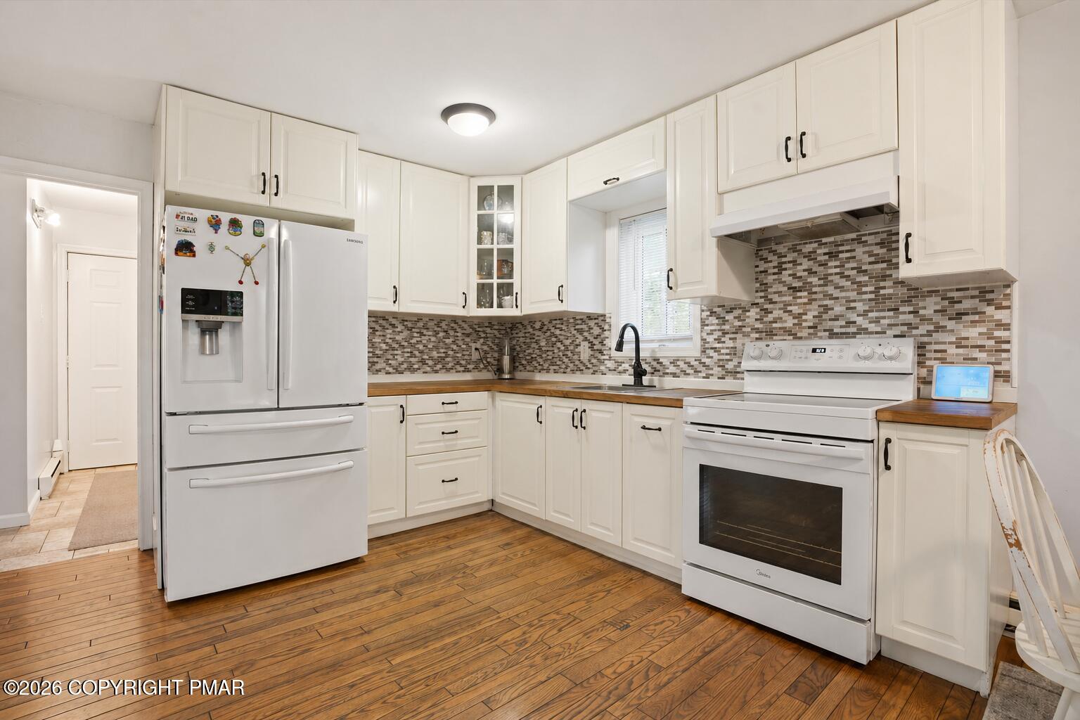53 Barren Road East Stroudsburg, PA 18302 - Photo 11 of 57 a kitchen with stainless steel appliances white cabinets and wooden floors