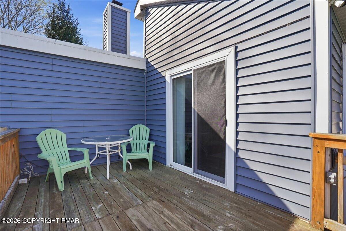 53 Barren Road East Stroudsburg, PA 18302 - Photo 30 of 57 a deck with a table and chairs and a barbeque with wooden floor