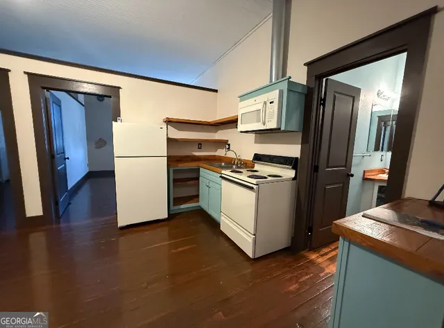 a kitchen with a refrigerator and a stove