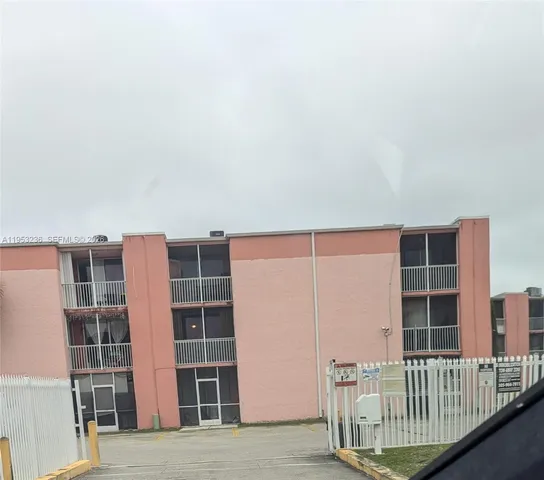 a view of front door with wooden floor and windows