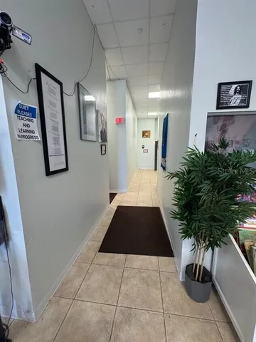 a hallway with plants and a potted plant