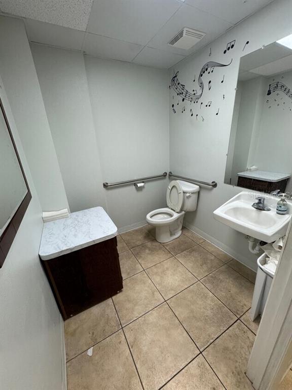 2050 Old Hickory Tree Road, Unit E St. Cloud, FL 34769 - Photo 10 of 10 a bathroom with a sink and a mirror