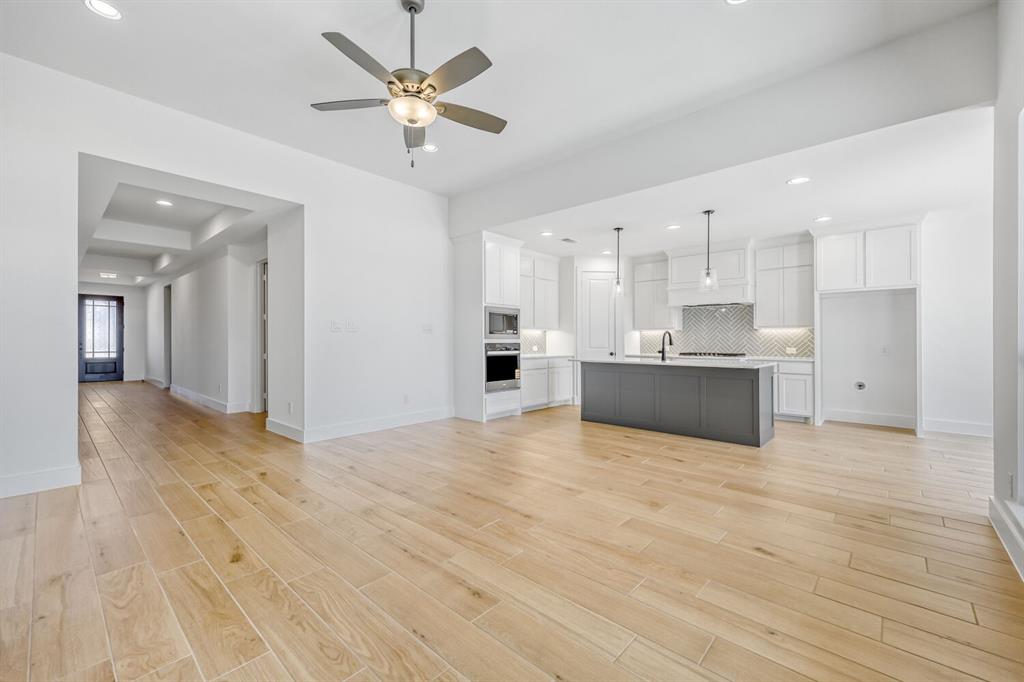 147 Derrett Lane Rhome, TX 76078 - Photo 28 of 28 a view of a kitchen with kitchen island a sink stainless steel appliances and cabinets