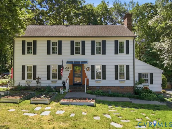 a front view of a house with a yard table and chairs