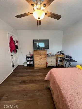 a bedroom with bed and a chandelier