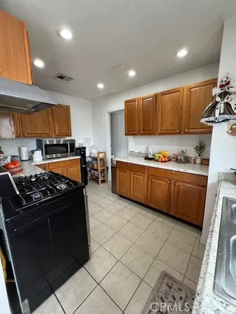 a kitchen with stainless steel appliances a stove a sink and a refrigerator