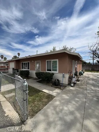 a view of a house with backyard porch and sitting area