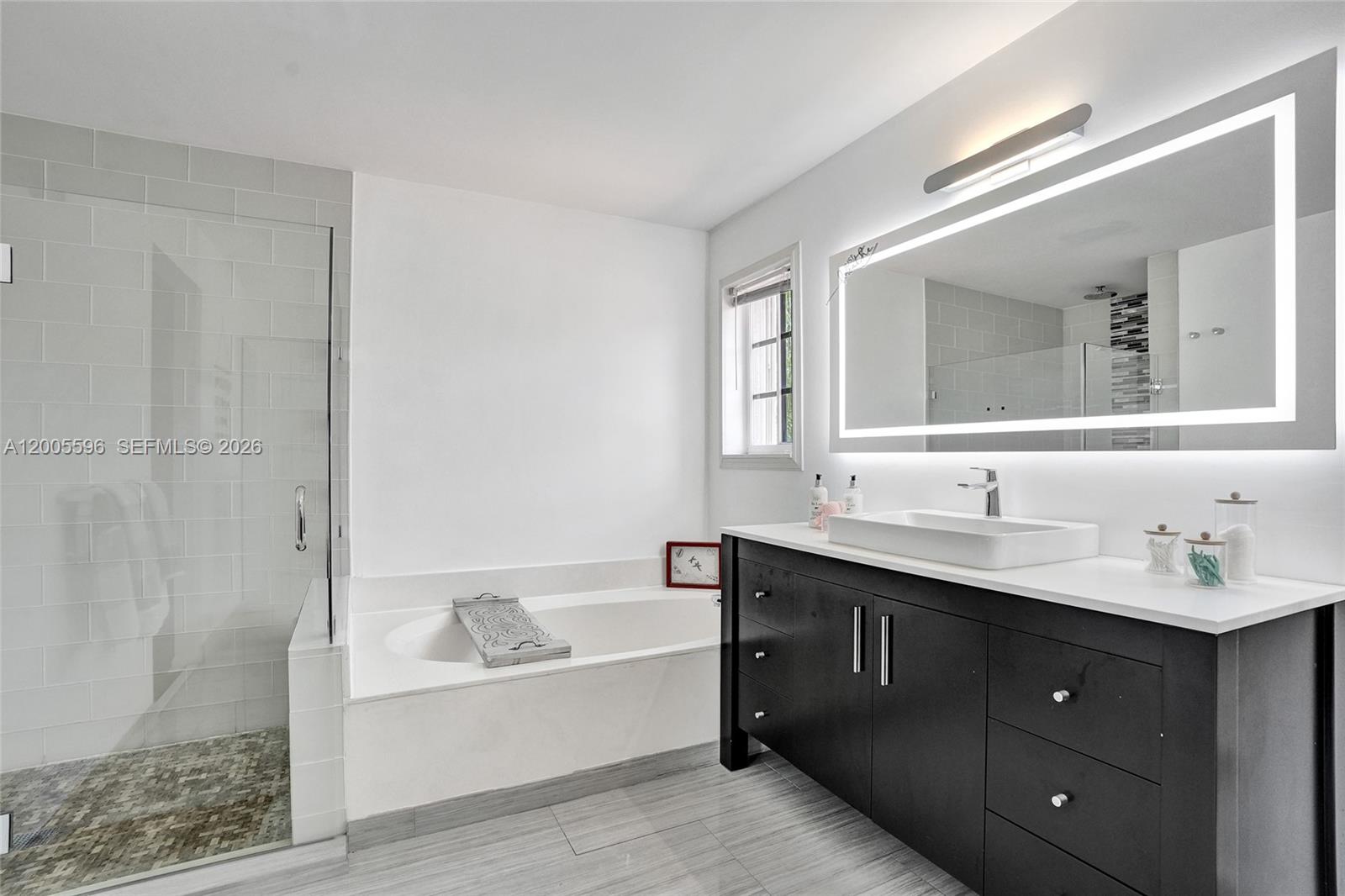 4281 Laurel Ridge Circle Weston, FL 33331 - Photo 48 of 80 a bathroom with a tub a sink and mirror