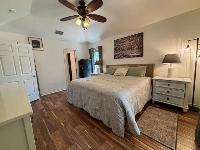 a view of an empty room with a fireplace and a window