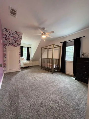 a spacious bathroom with a double vanity sink mirror and toilet