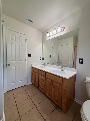 a bedroom with furniture and a wooden floor