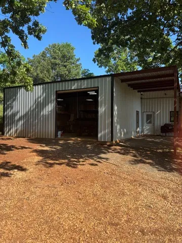 a large kitchen with kitchen island a large counter top space a sink stainless steel appliances and cabinets