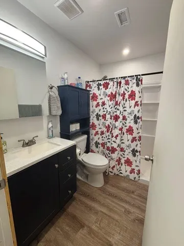 a bedroom with a bed and a tv on table