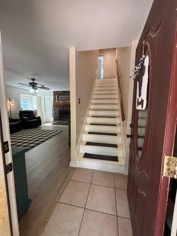 a living room with furniture fireplace and flat screen tv
