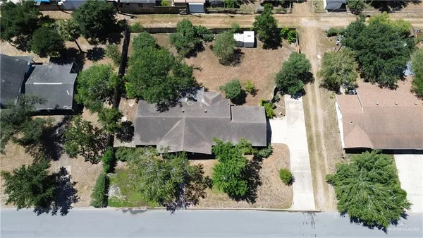 an aerial view of a house with a yard and lake view