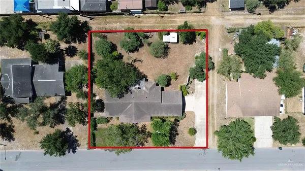 an aerial view of a house with a yard and garden