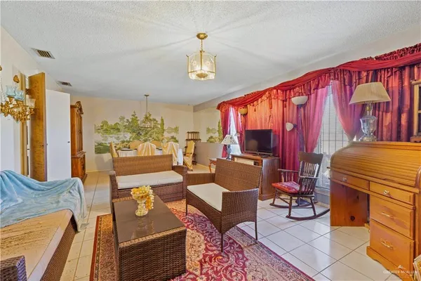 a living room with furniture a rug and a chandelier