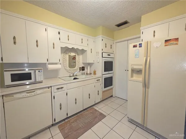 a kitchen with cabinets and stainless steel appliances