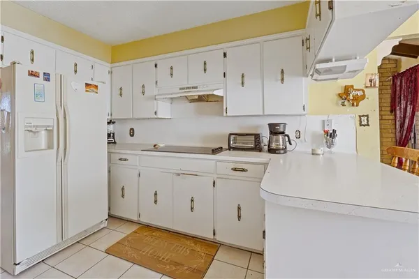 a kitchen with cabinets appliances and a counter space