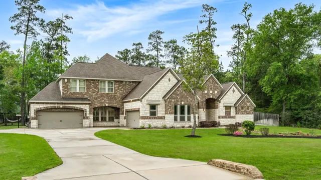 a front view of a house with a garden and yard