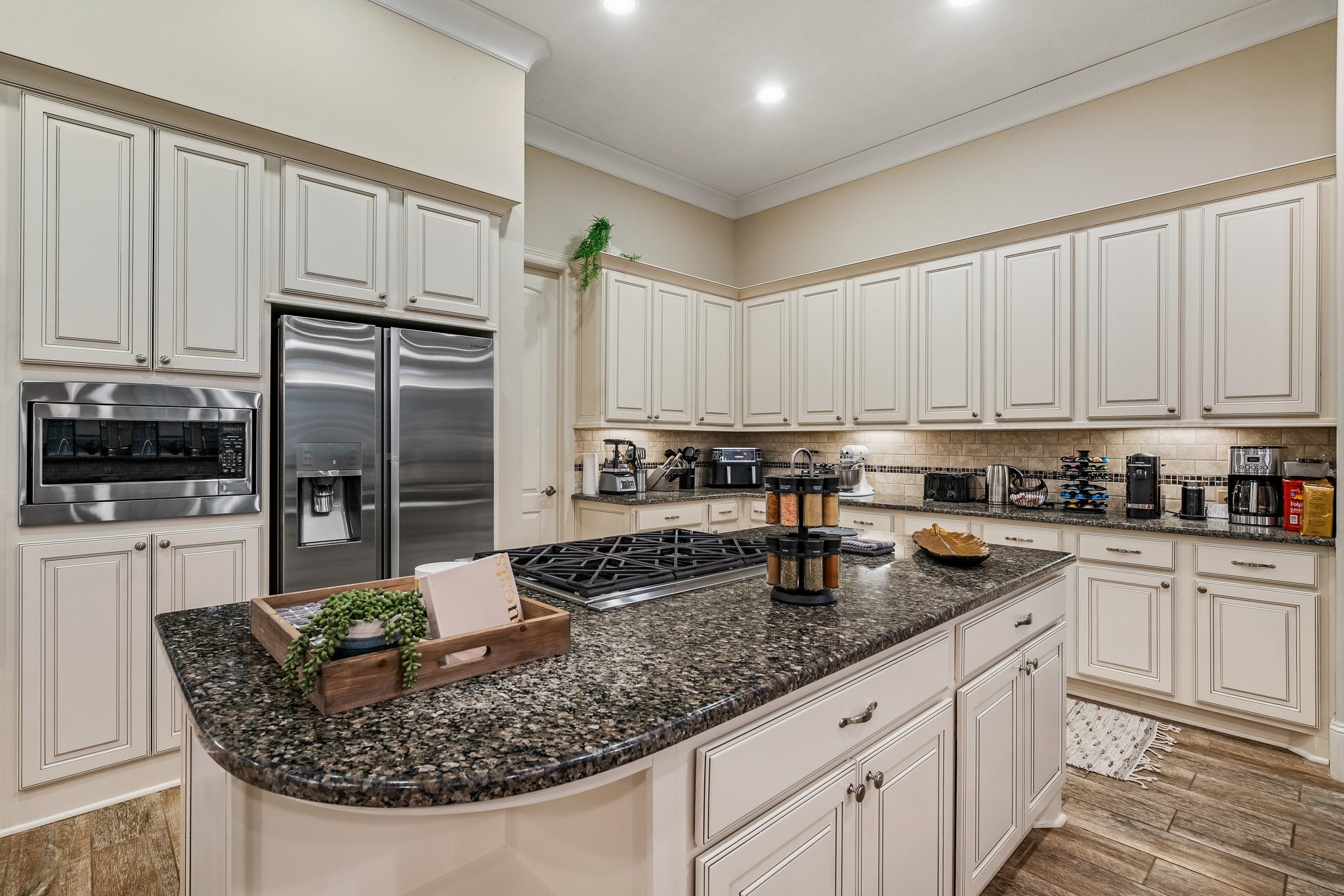 27411 Hazy Landing Court Spring, TX 77386 - Photo 12 of 50 a kitchen with stainless steel appliances granite countertop a stove top oven a refrigerator a sink and white cabinets