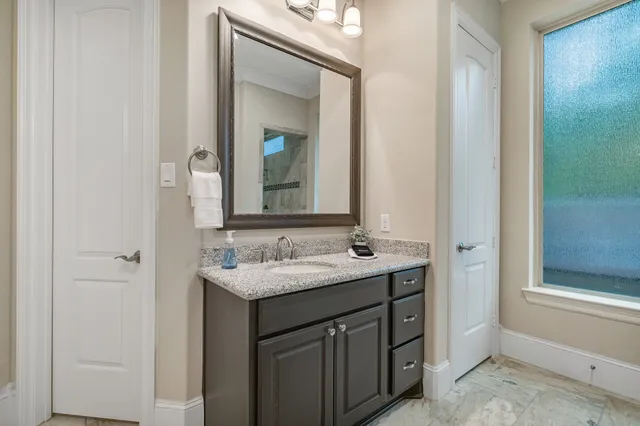 a bathroom with a double vanity sink and a mirror