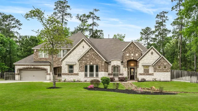 a front view of a house with a garden and porch