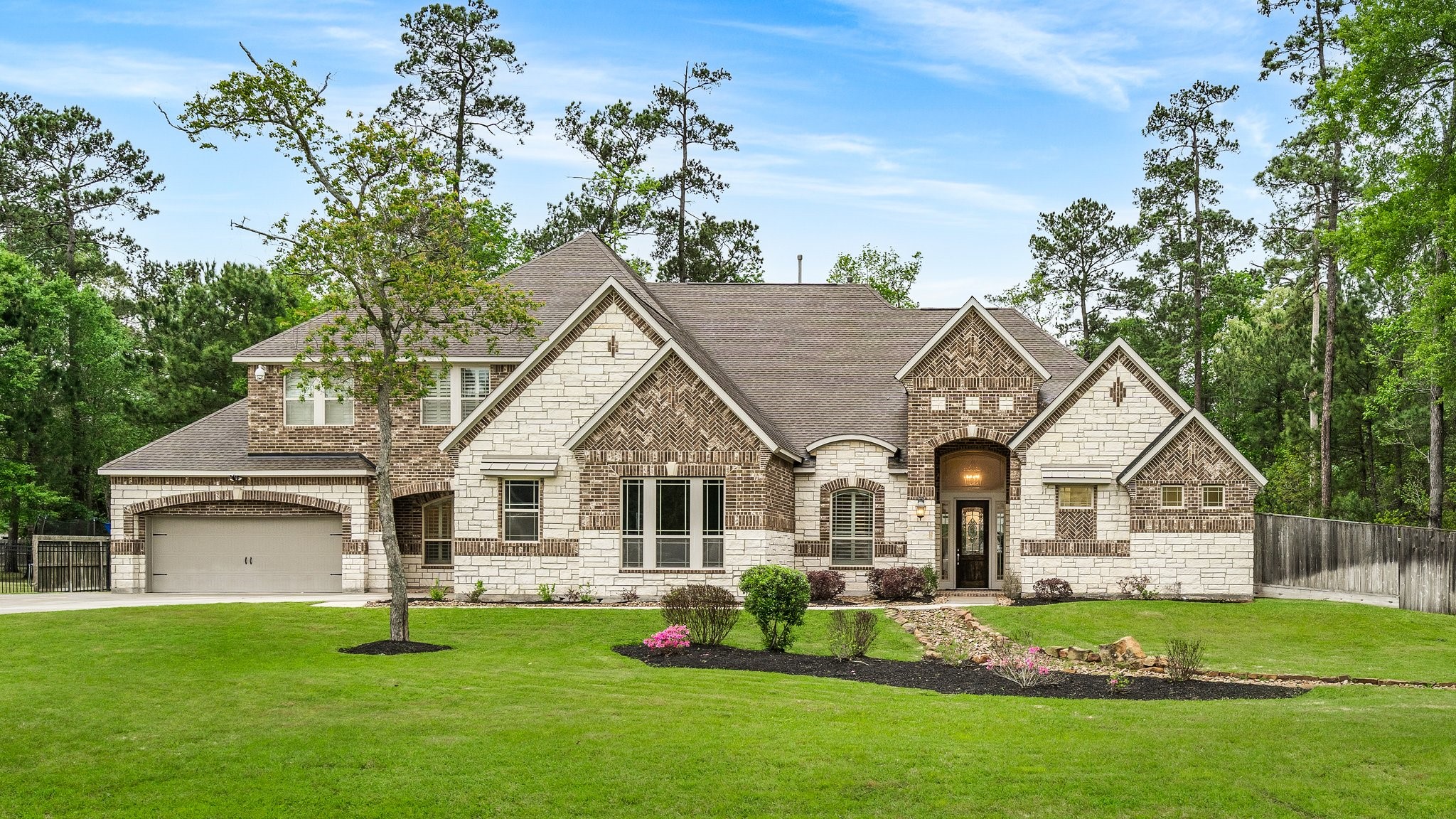27411 Hazy Landing Court Spring, TX 77386 - Photo 3 of 50 a front view of a house with a garden and porch